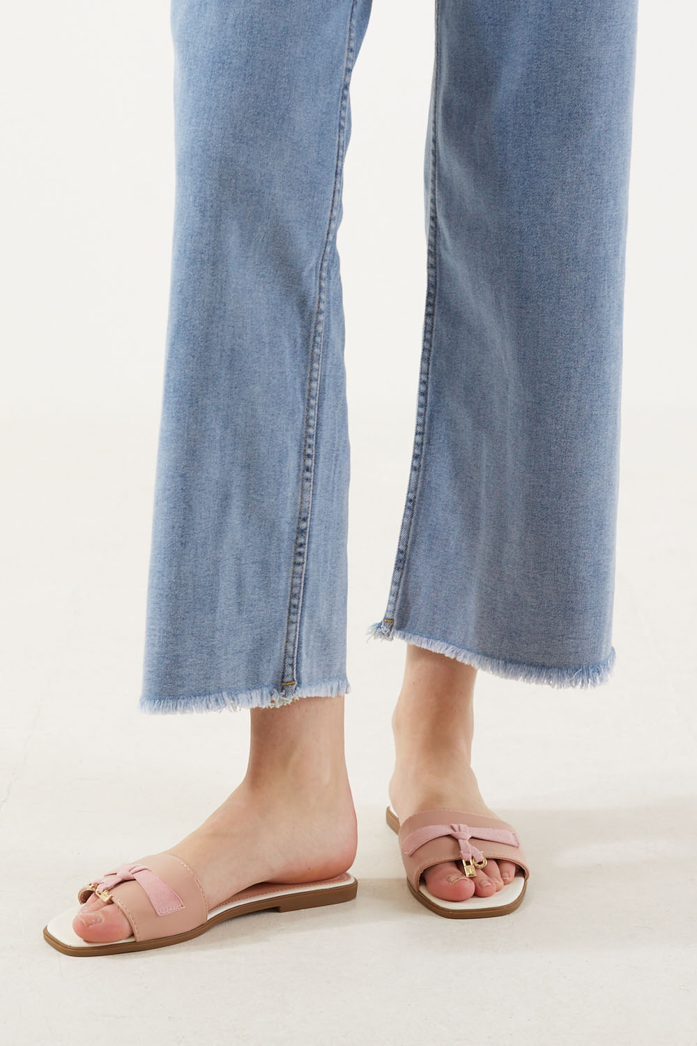 Dallia Pink Tassel Lock Leather Slippers in White