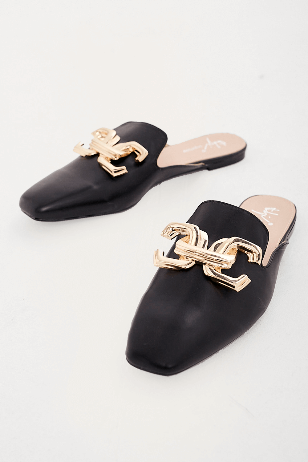 https://www.iclothing.com/media/catalog/product/d/e/delia_gold_buckle_mule_loafers_in_black-1.png